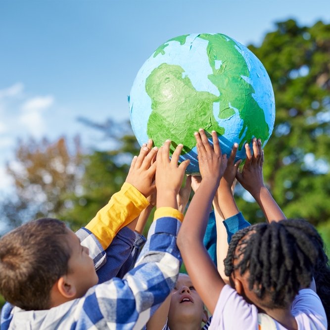 children holding up a globe